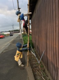 子どもが梯子を登っている案山子。